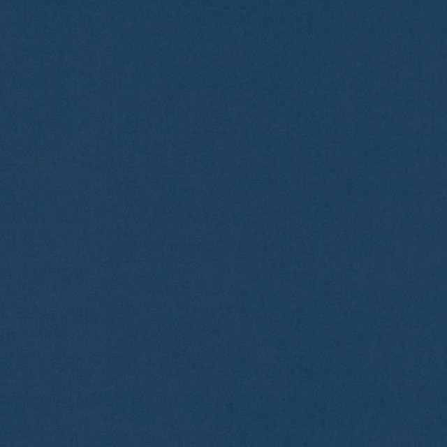 Deep indigo-blue plain weave with subtle tonal texture in close-up