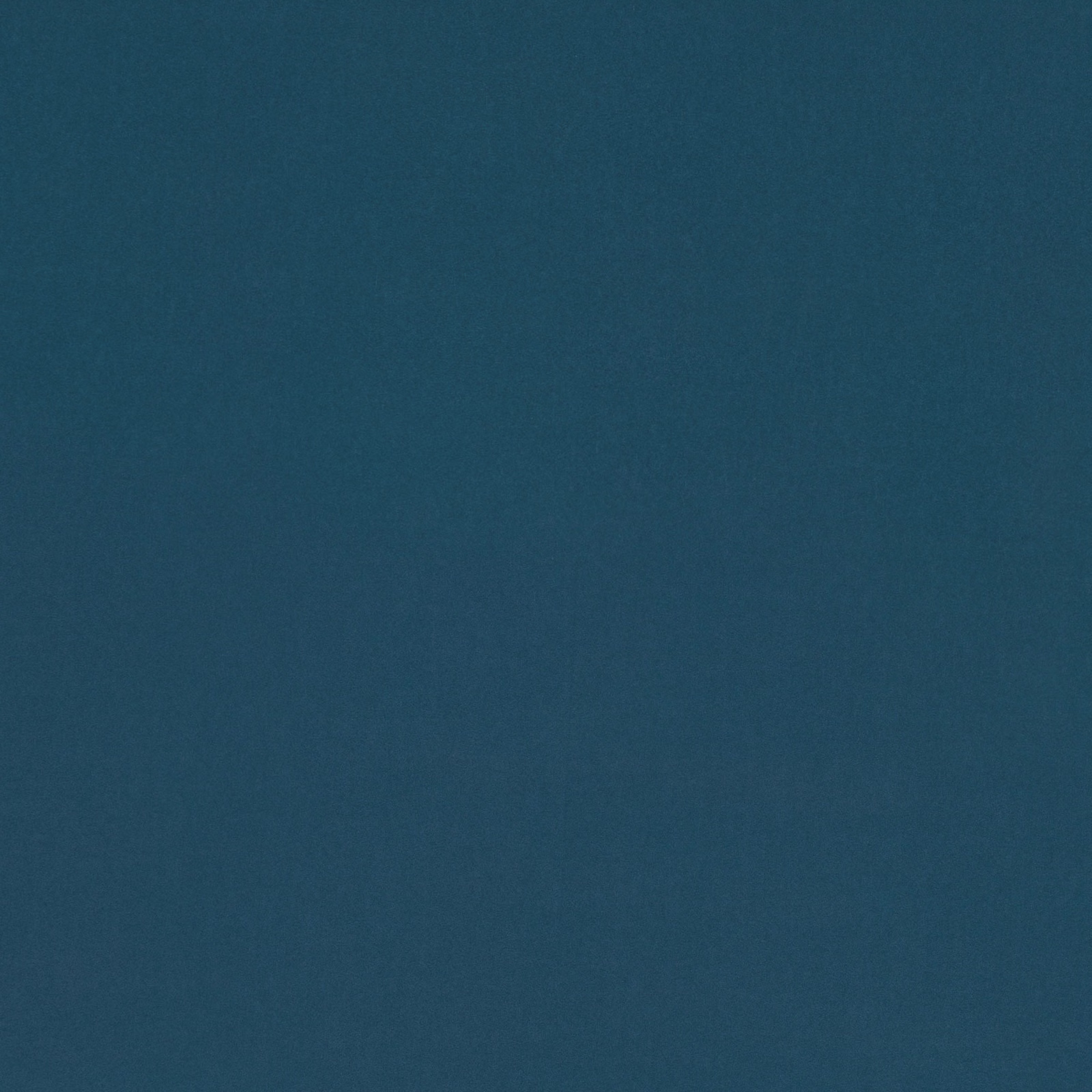 Close-up of deep blue-green teal fabric with a softly mottled plain texture