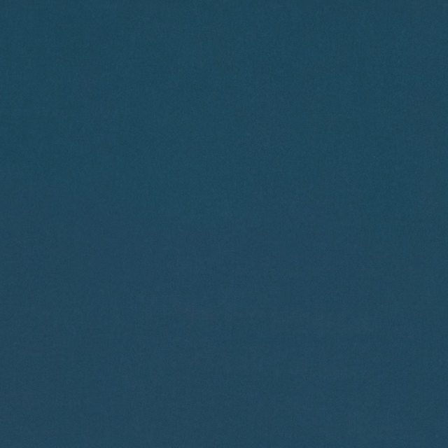 Close-up of deep blue-green teal fabric with a softly mottled plain texture