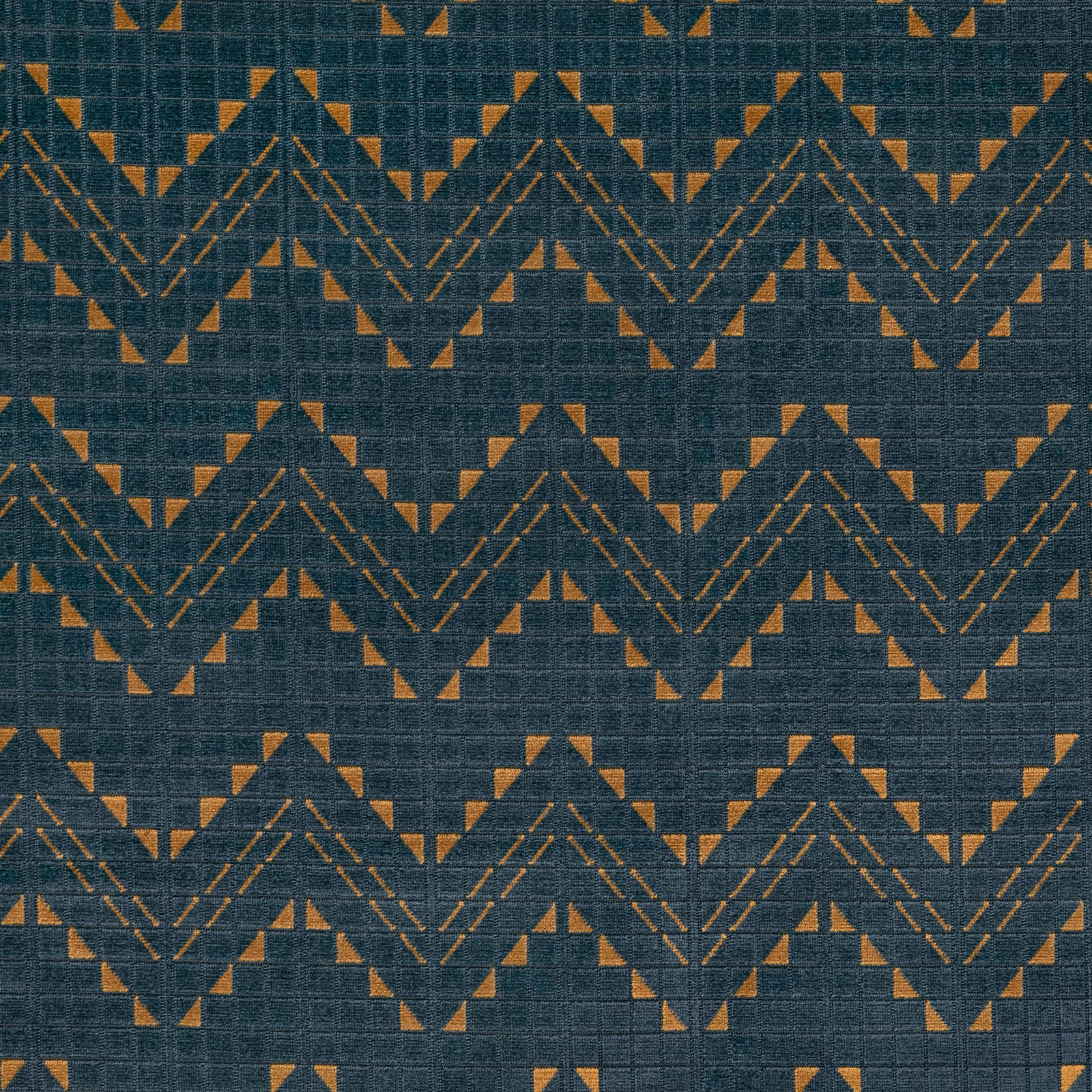 Dark petrol woven ground with rust-gold geometric chevrons and triangular accents