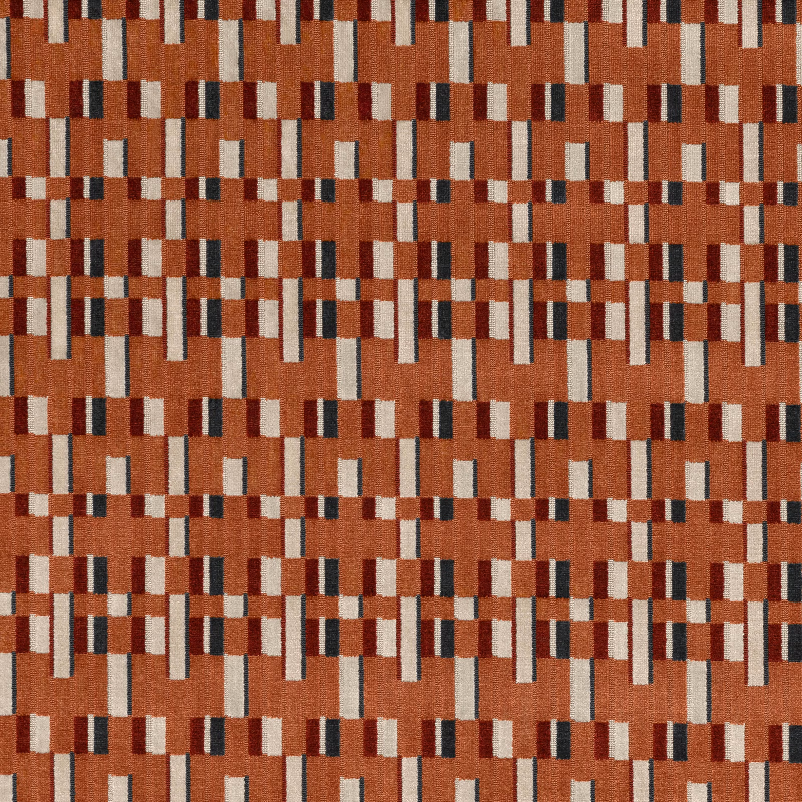 Burnt orange woven textile with cream, burgundy and charcoal broken-block motif