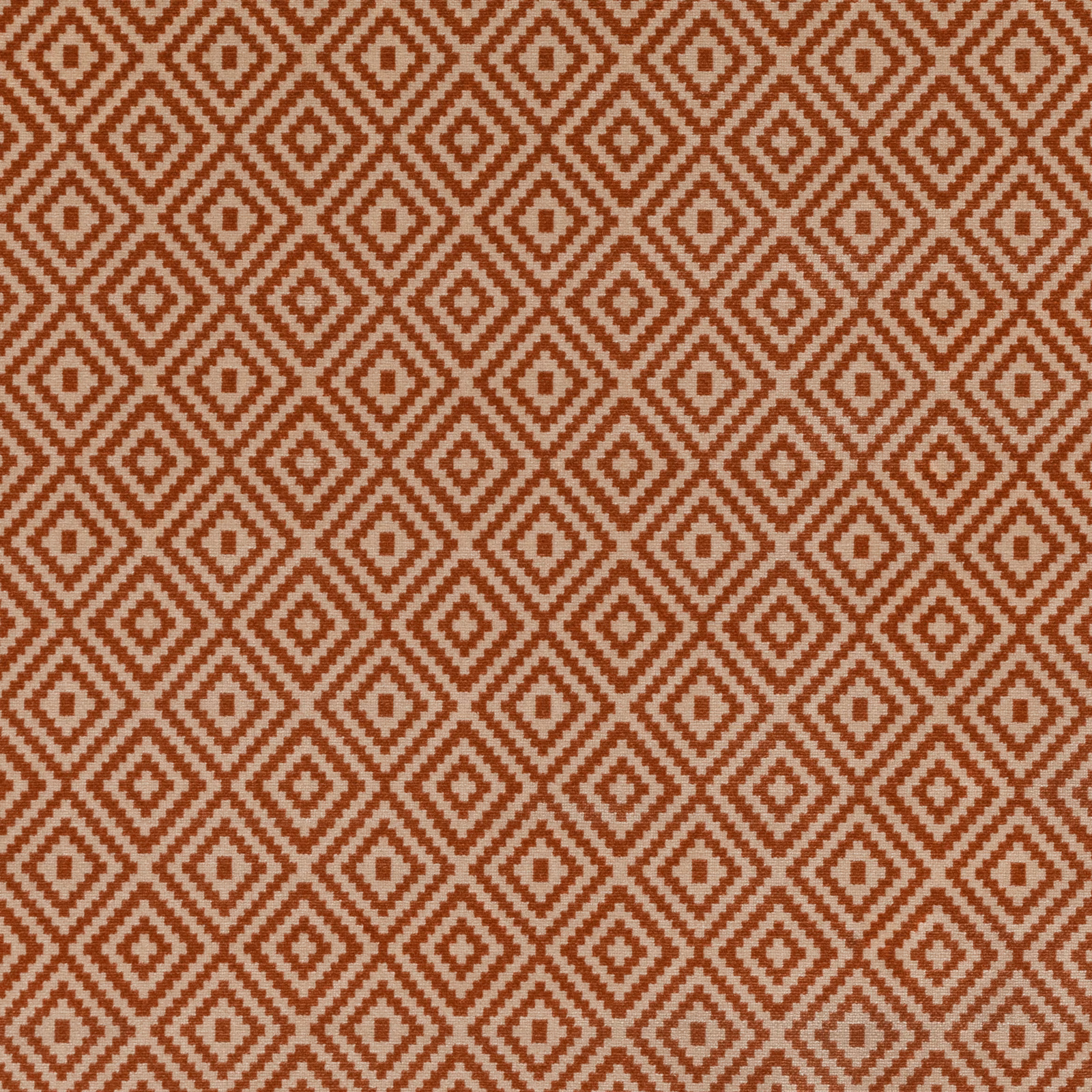 Burnt-orange and ivory woven fabric with repeating stepped diamond motifs