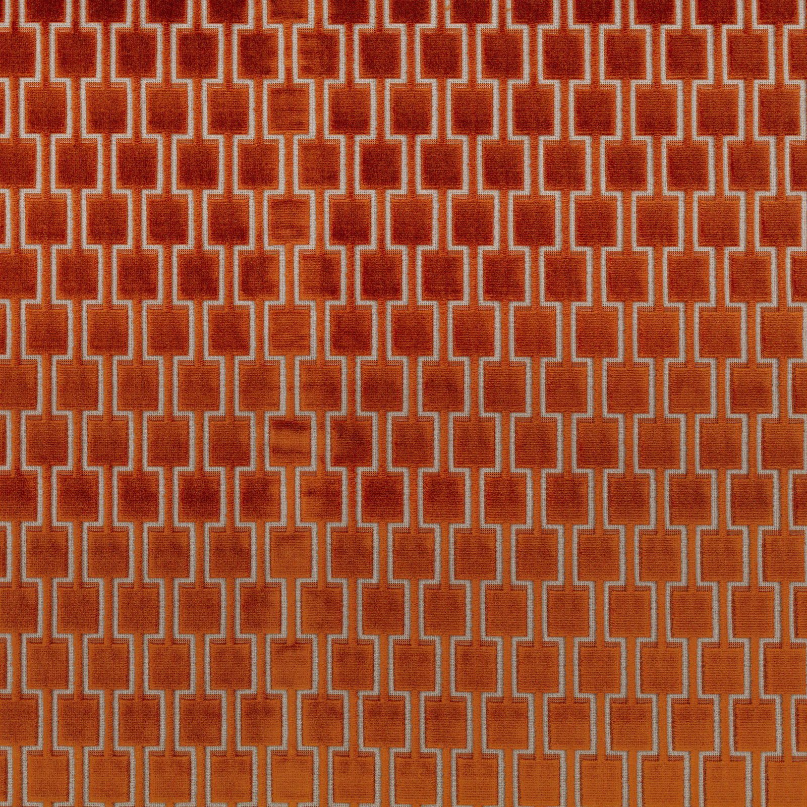 Rust-cinnamon geometric fabric with pale linked lines and a softly textured surface