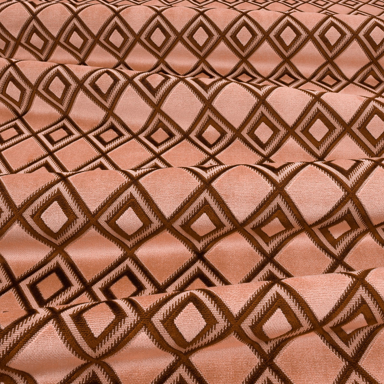Dusty pink woven fabric with contrasting brown interlocking diamond motifs and tactile texture