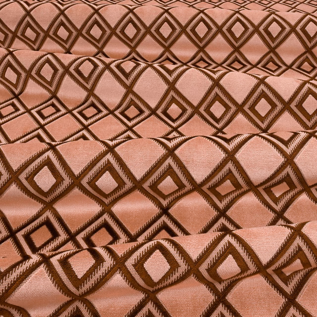 Dusty pink woven fabric with contrasting brown interlocking diamond motifs and tactile texture