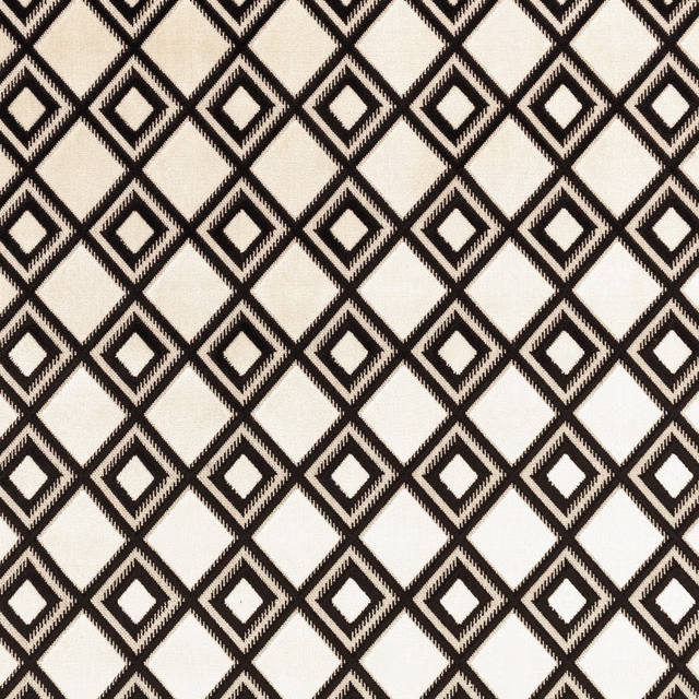 Black and ivory woven fabric with repeating nested diamond geometry