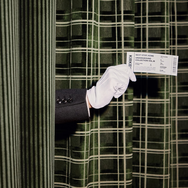 Deep pine-green plaid fabric with pale grid lines and softly folded texture