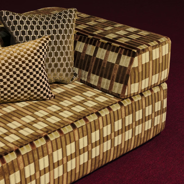 Olive-brown, tobacco and cream geometric checked upholstery covering a sofa and cushions