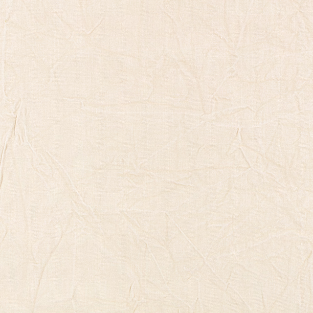 Pale cream plain textile with fine weave and irregular crinkled creases