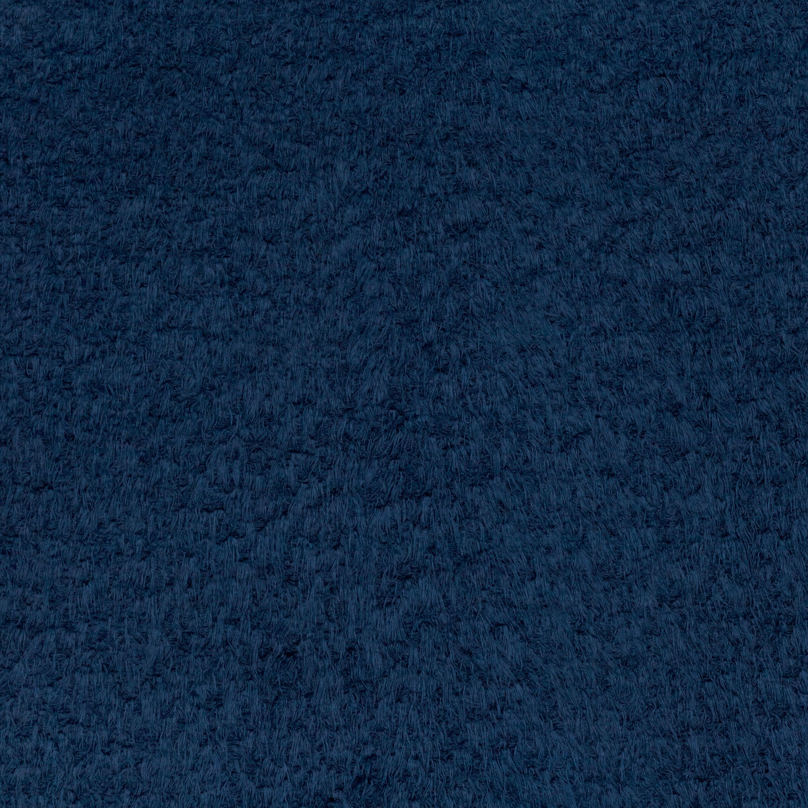 Close-up of dense midnight-blue brushed fibres with softly mottled dark texture