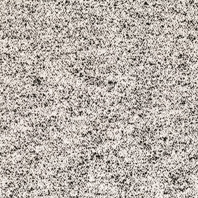 Ivory fabric densely scattered with irregular black flecks and tactile woven texture