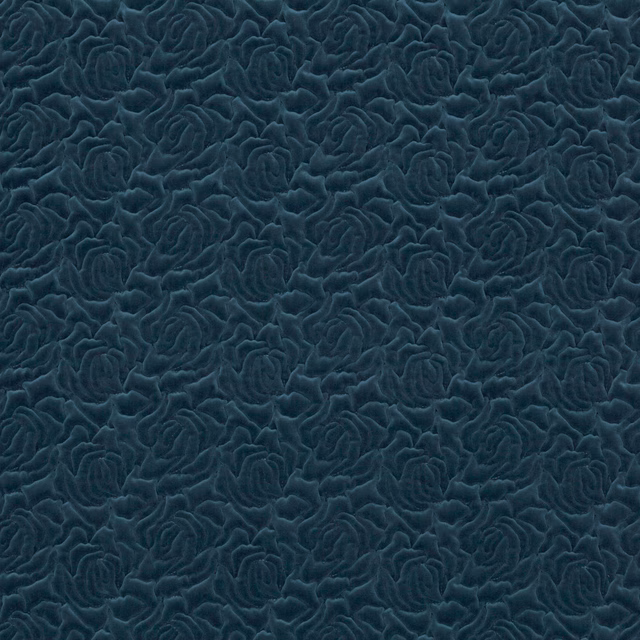 Deep indigo-blue fabric with raised, closely packed roses and soft tonal sheen