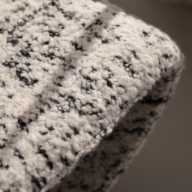 Ivory bouclé upholstery fabric with irregular charcoal flecks and a chunky raised texture