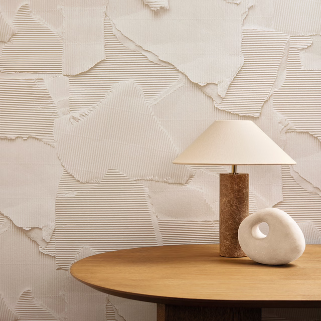 Warm ivory wallpaper with torn layered panels and fine horizontal ribbing