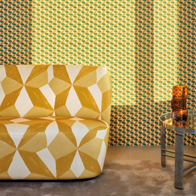 Small geometric wallpaper in teal, ochre, green and cream with angular repeating motifs