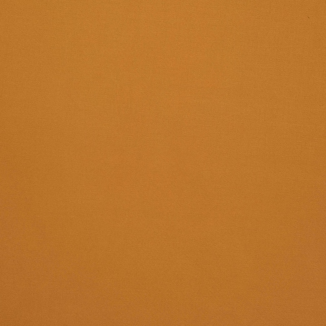 Close-up of warm amber-orange textile with an even surface and subtle fine texture