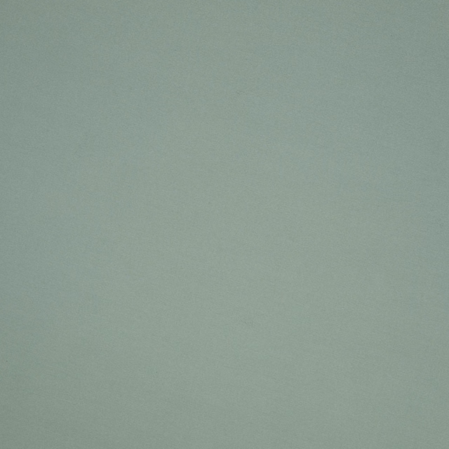 Close-up of softly textured cool celadon green plain fabric