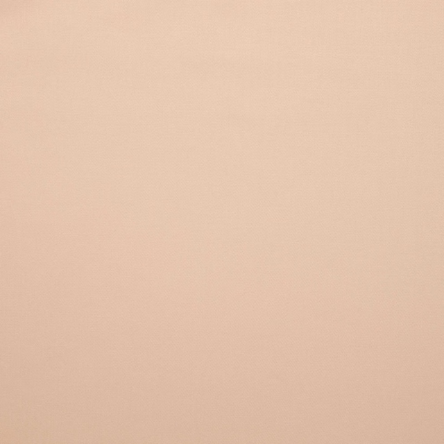 Soft blush-pink plain textile with a faintly textured, even surface