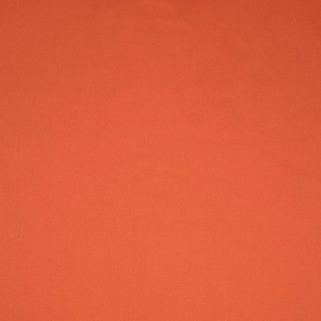 Warm sienna-red plain fabric swatch with a subtly textured woven surface