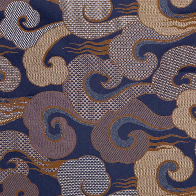 Deep indigo textile with taupe, grey and cream interlocking scroll motifs