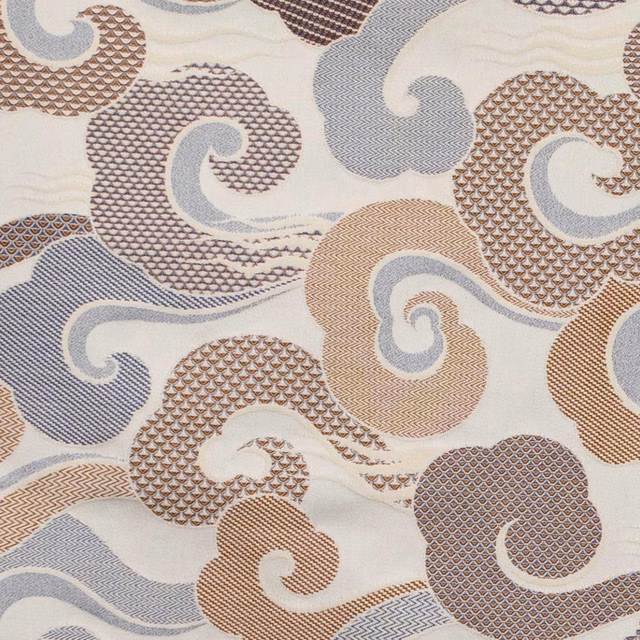 Cream woven textile with blue-grey, taupe and brown curling spiral motifs