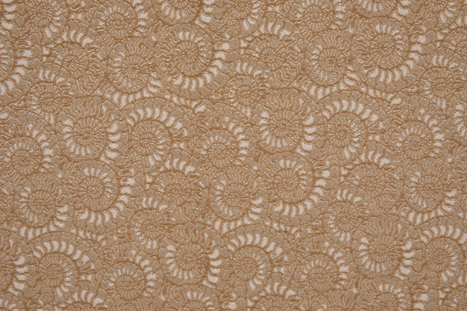 Warm ochre-beige textile with densely packed cream spiral-shell motifs and fine woven texture