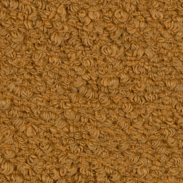 Close-up of ochre-gold looped textile with brown flecks and dense tactile relief