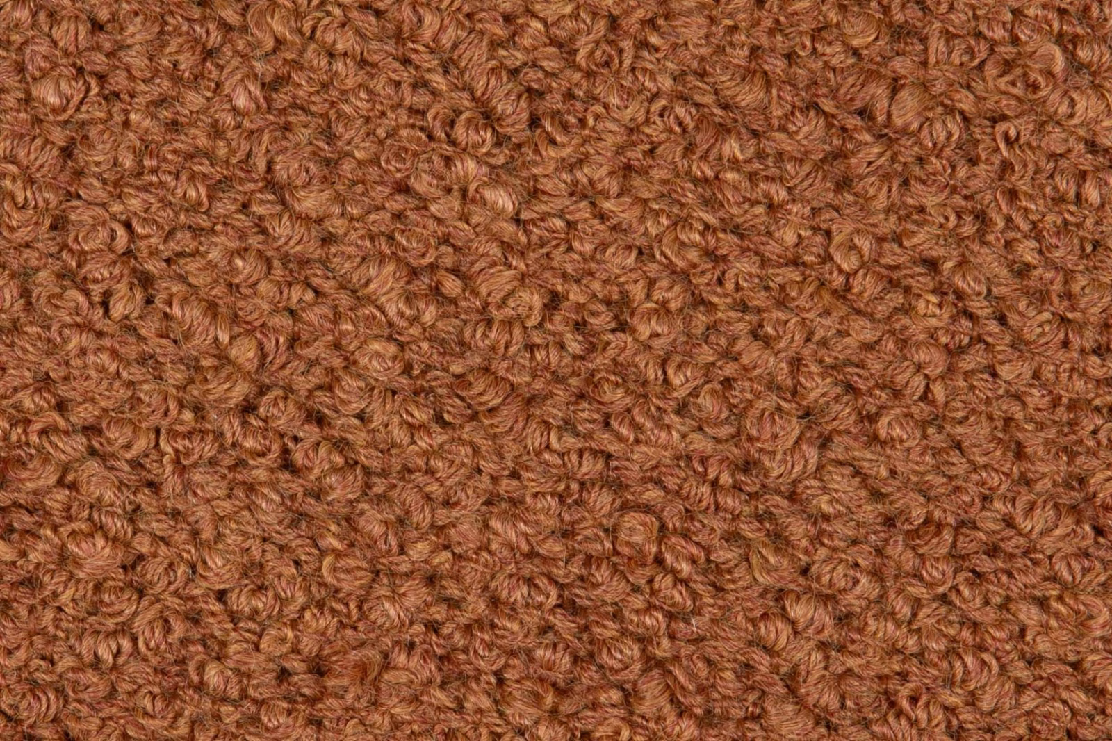 Close-up of densely looped terracotta-brown bouclé texture with subtle tonal variation
