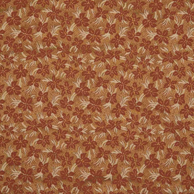 Copper-rust floral fabric with cream leafy sprigs in a textured woven pattern