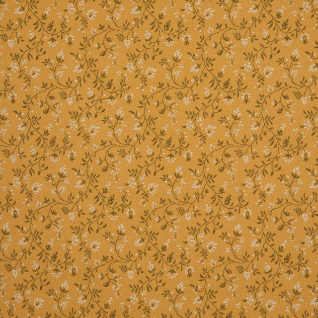 Warm ochre-gold textile with small pale blossoms and curling dark stems