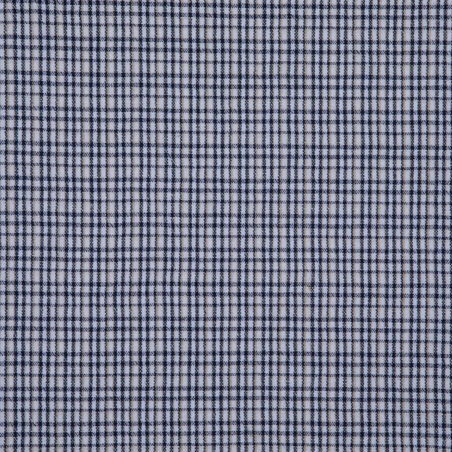 Ink-blue and pale grey micro-check textile showing a tightly structured woven surface