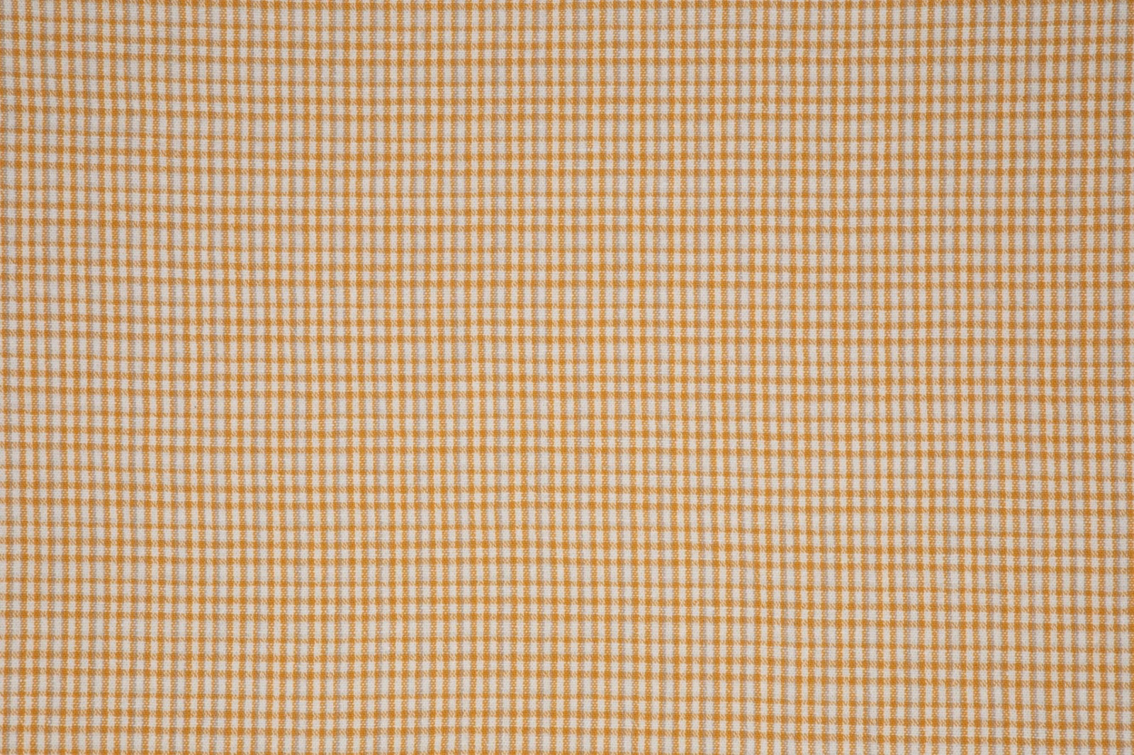 Warm ochre and cream small-check textile with a finely textured woven appearance