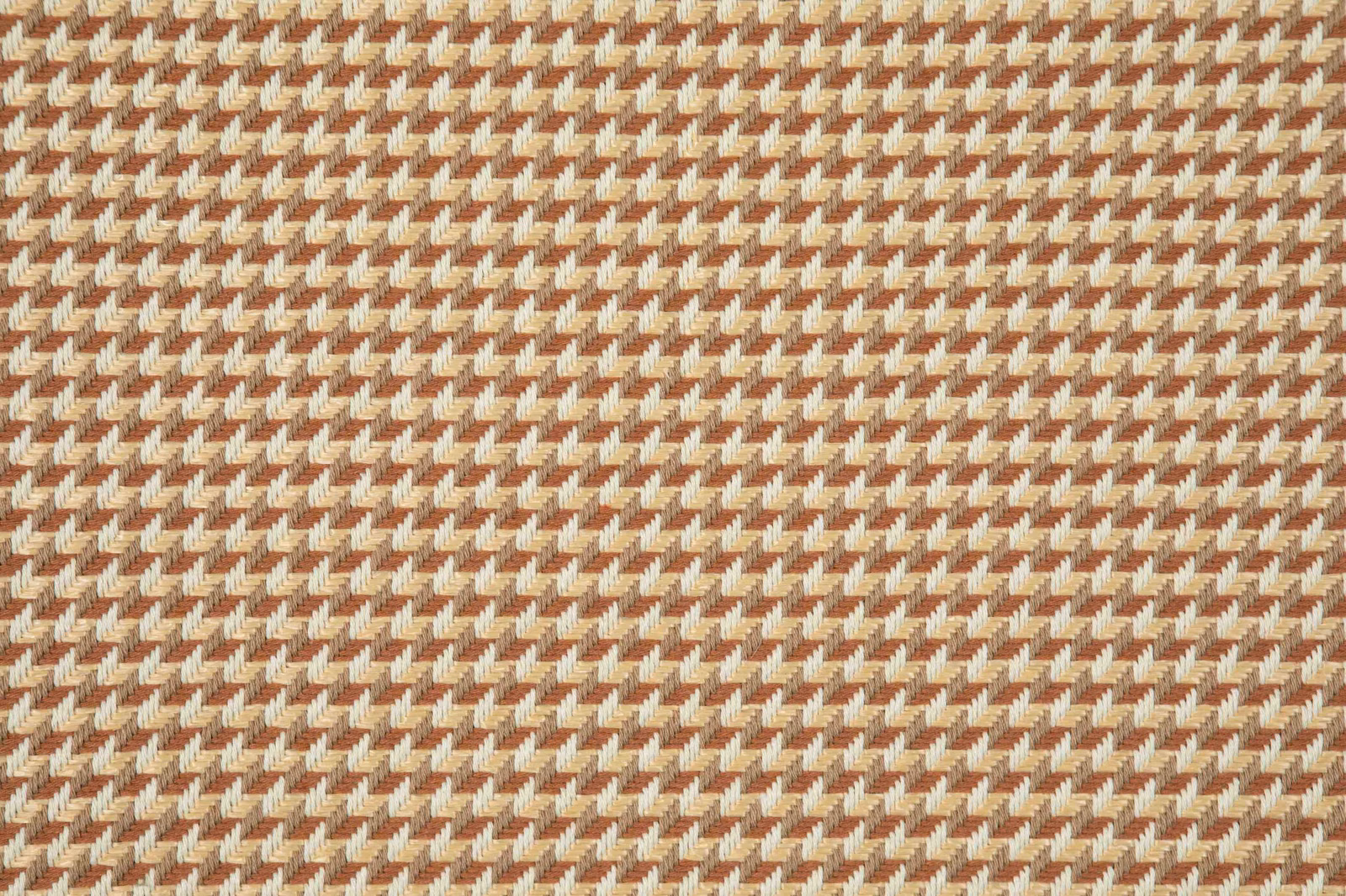 Close view of terracotta and cream woven micro-houndstooth texture