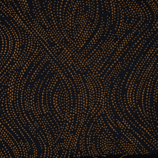 Near-black woven textile with copper dotted waves curling across the surface