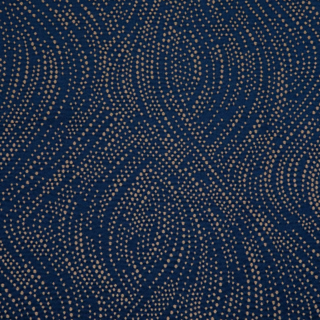 Deep ink-blue textile with ochre dotted waves forming a fluid all-over pattern