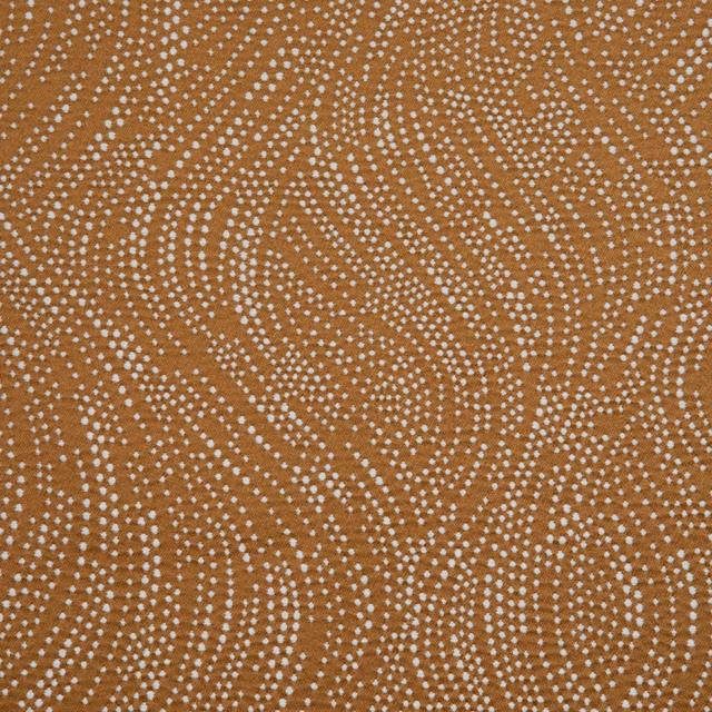 Warm gazelle-brown textile with flowing ivory dotted wave motifs and a softly textured surface
