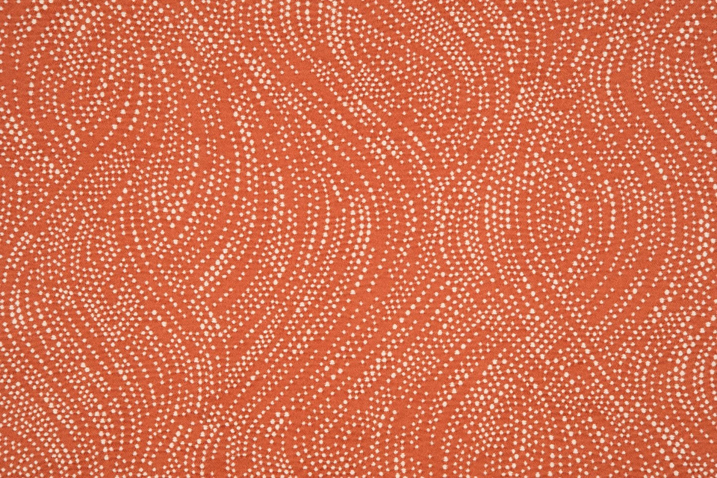 Paprika terracotta textile with cream dotted wave bands and a fine surface