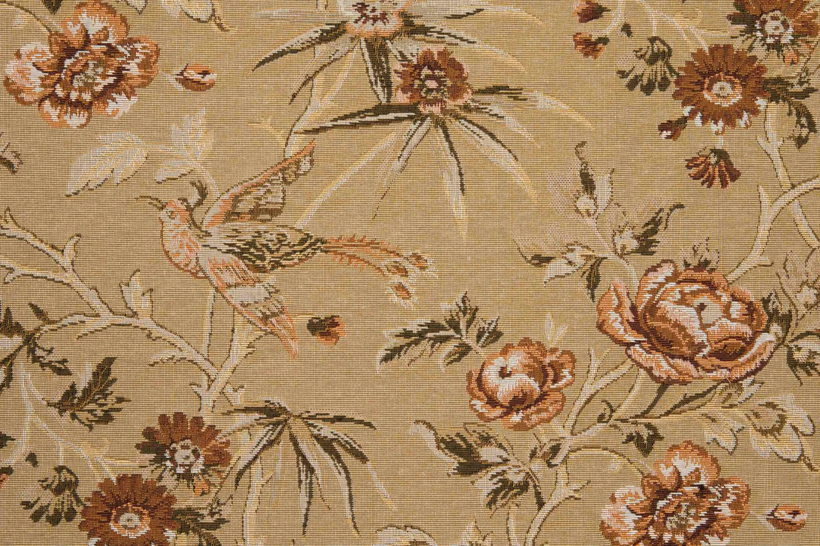 Warm paille beige woven fabric with rust florals, trailing foliage and a detailed bird motif