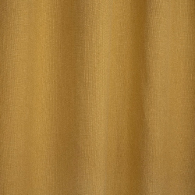 Warm ochre-gold plain fabric with subtle weave and softly shaded vertical folds