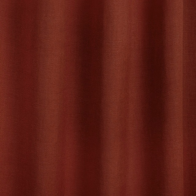 Deep terracotta-red fabric with fine vertical texture and softly shaded folds