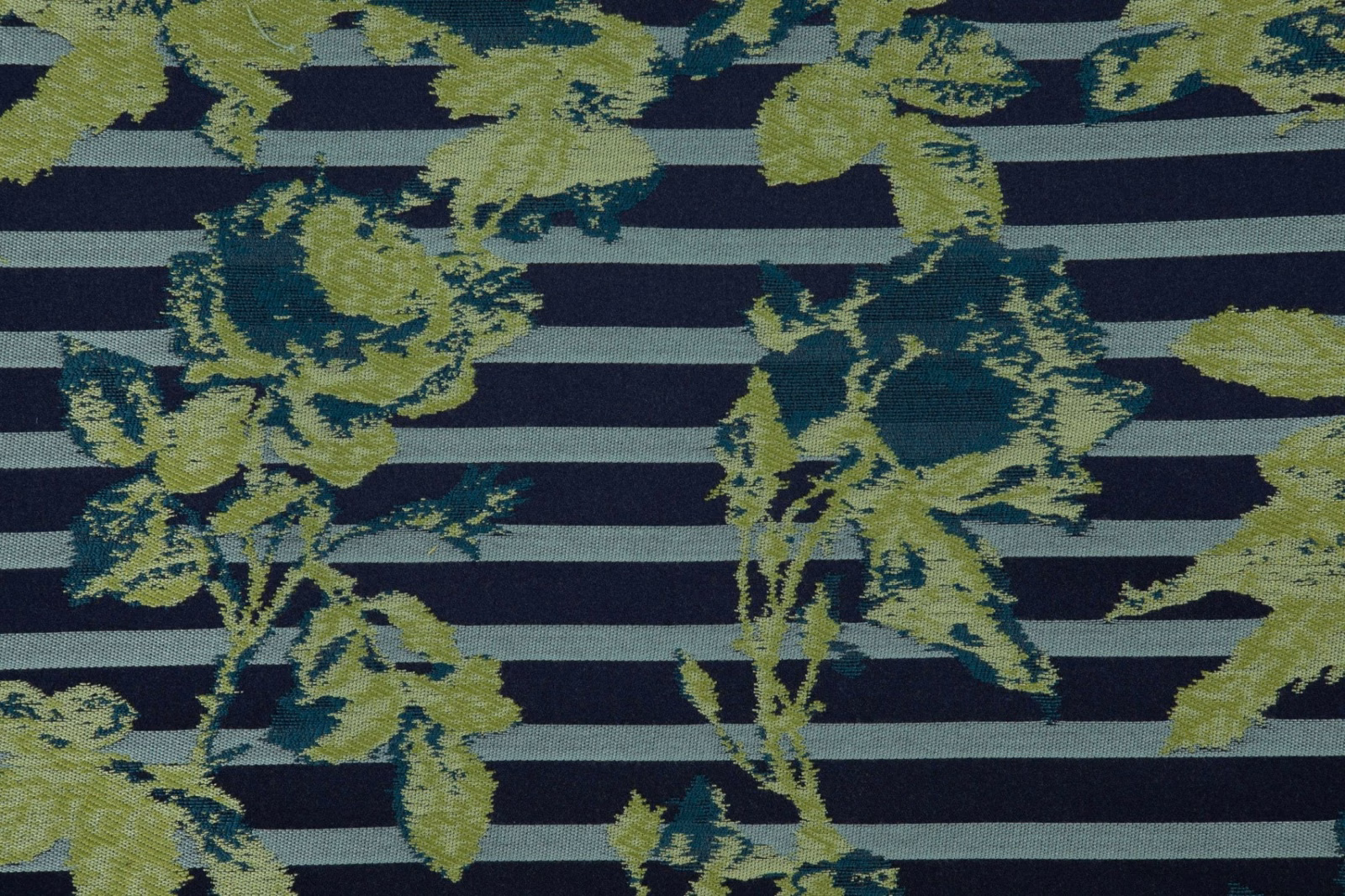 Navy striped textile with olive botanical sprays and a softly ridged woven surface