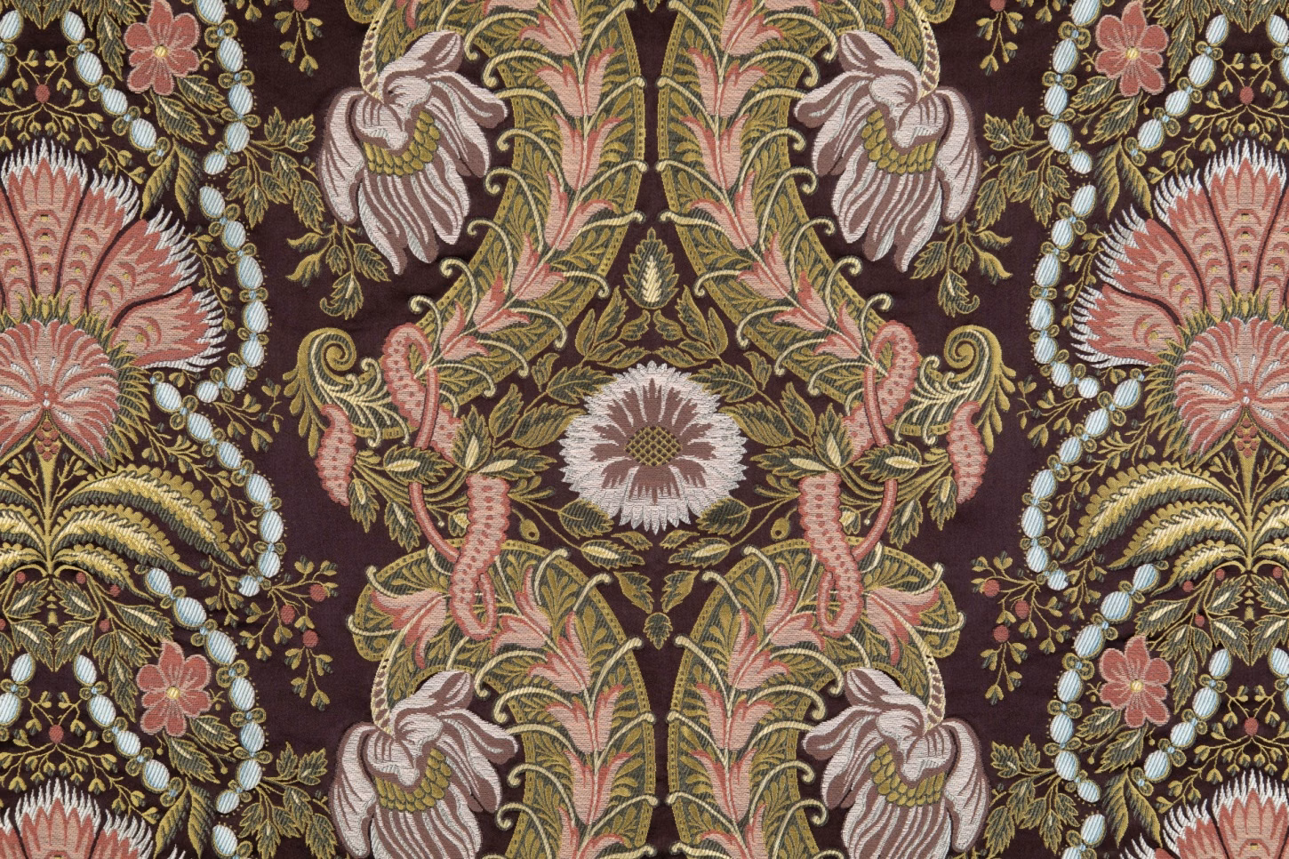 Deep plum textile with mirrored pink, sage, ivory and gold floral motifs