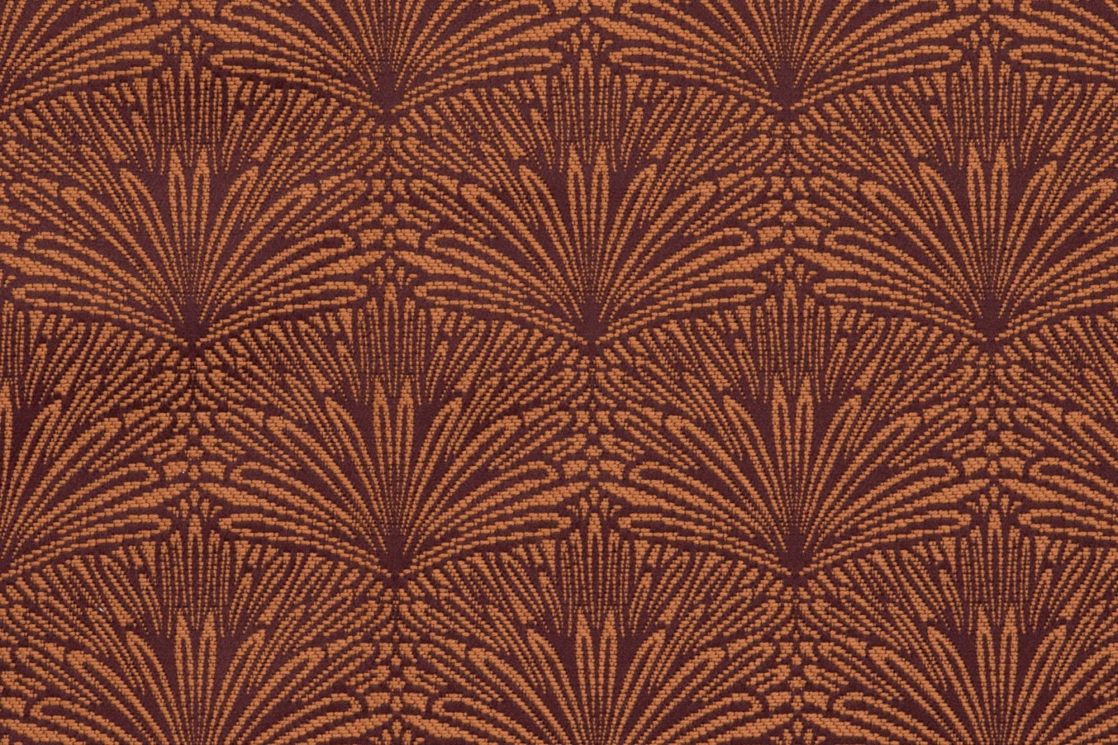 Aubergine-brown textile with repeating copper Art Deco fan motifs and fine woven texture