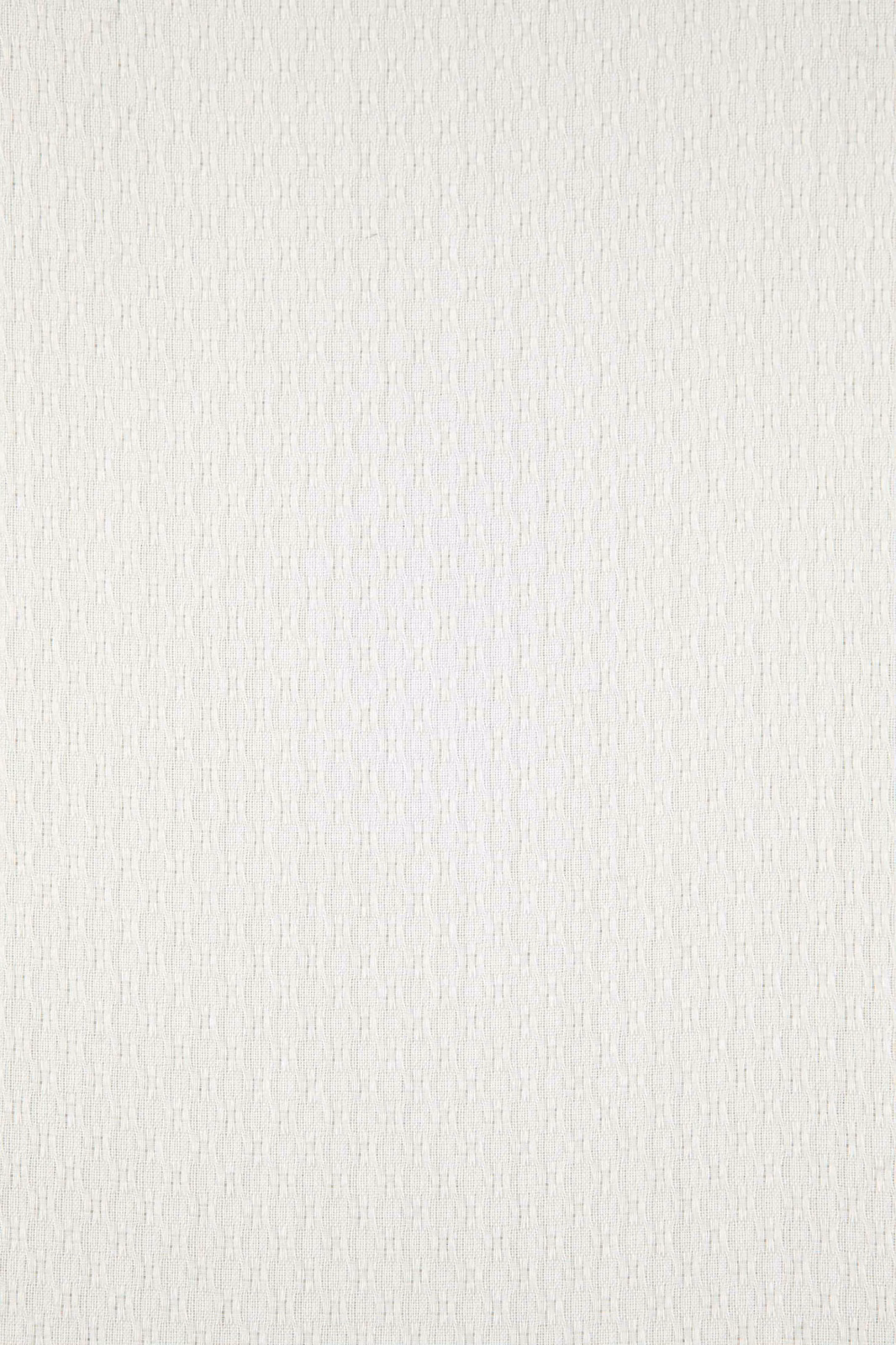 Close-up of pale ecru fabric with a fine, softly irregular vertical weave
