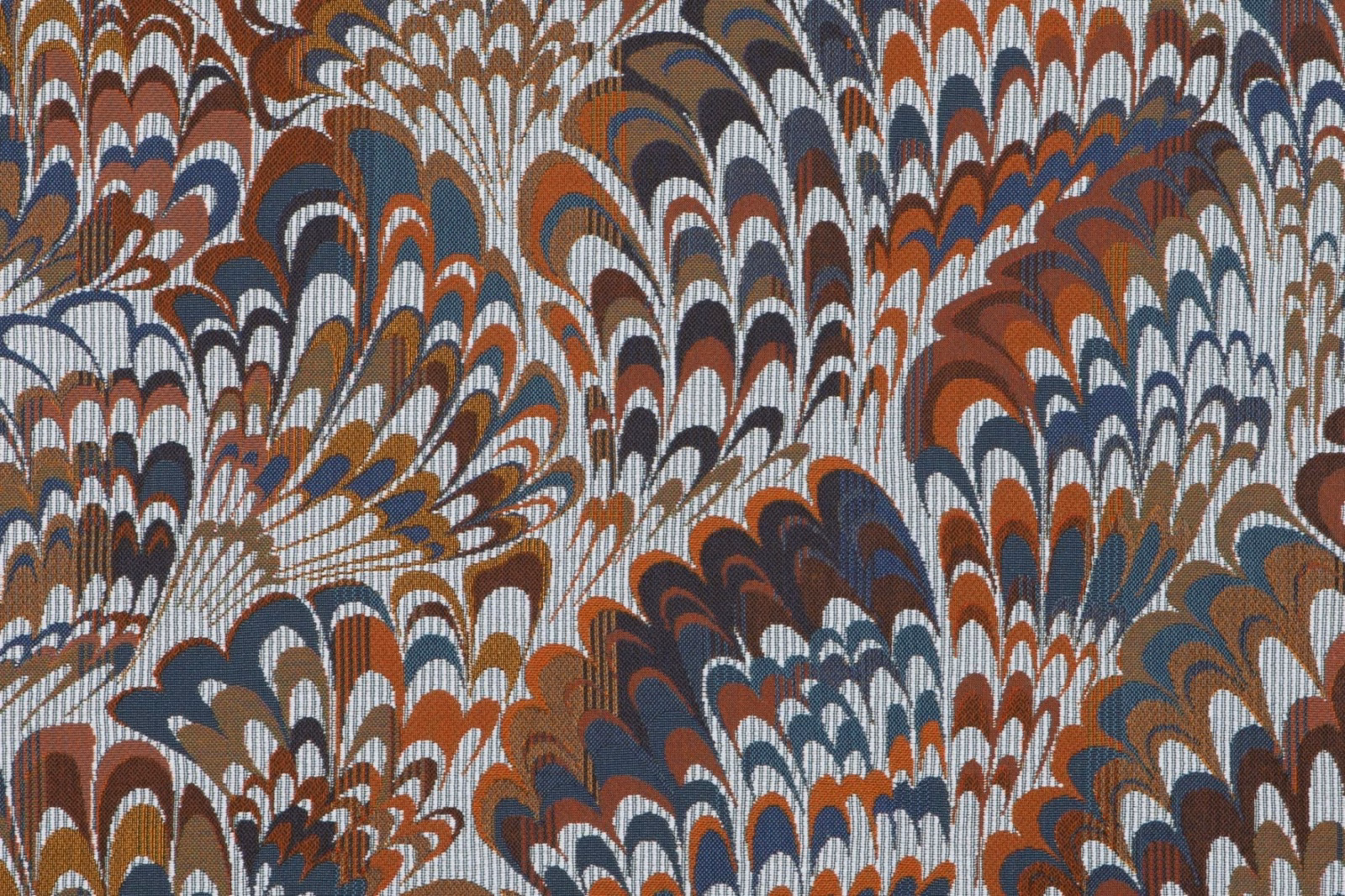 Indigo textile with rust, brown and cream fan-like feather motifs in a dense weave