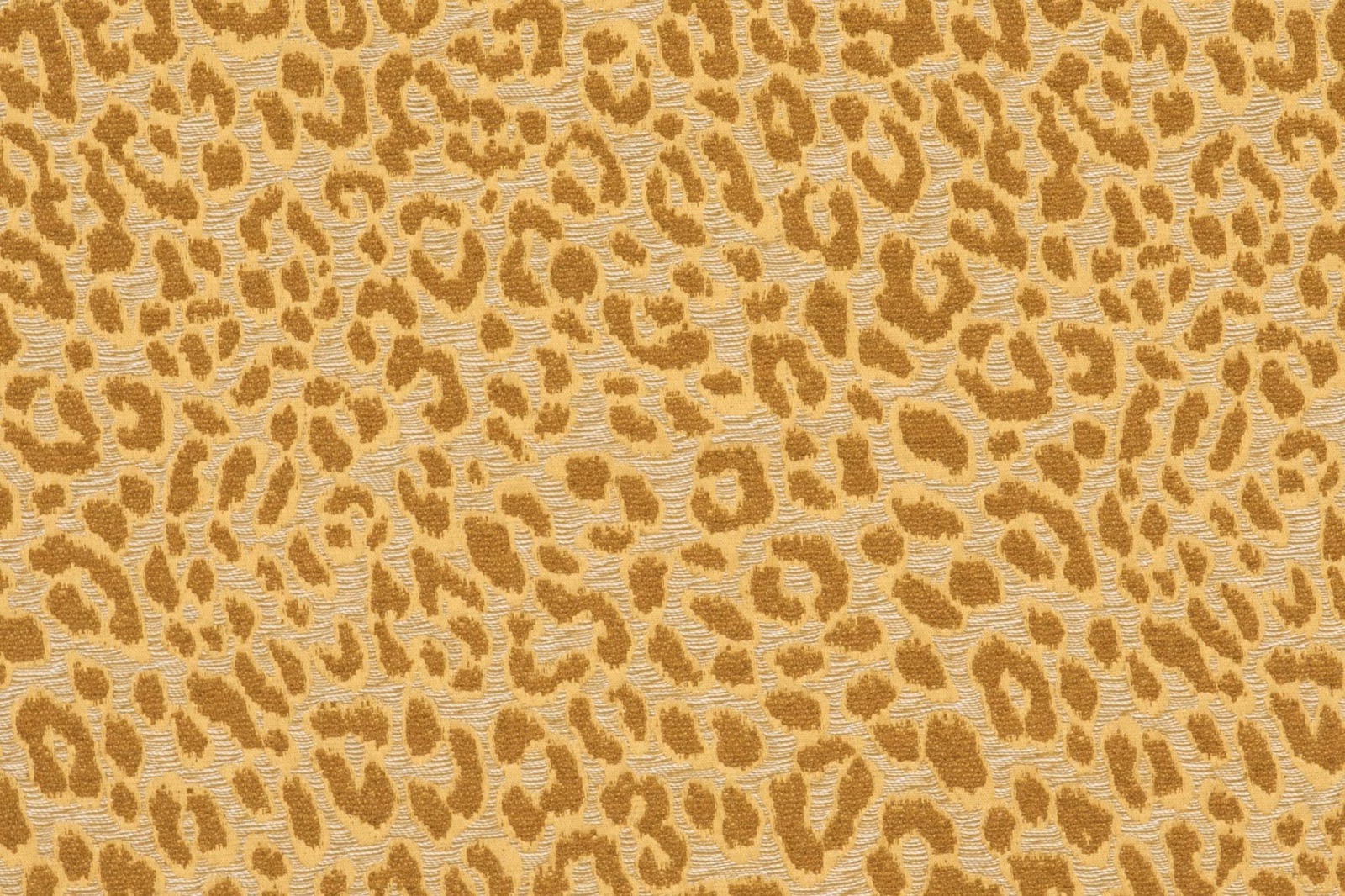 Warm ochre animal spots across a nubby ivory-beige woven ground