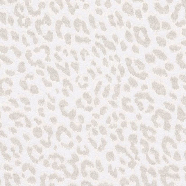 Warm ivory fabric with small pale greige animal spots and subtle texture