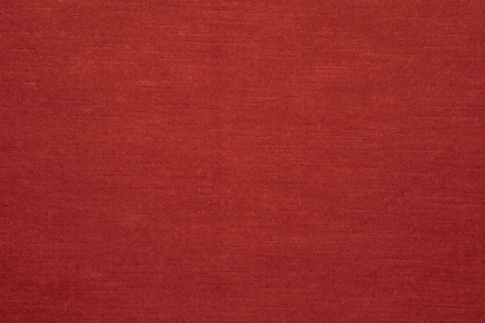 Deep ruby-red woven textile with subtle horizontal slub texture