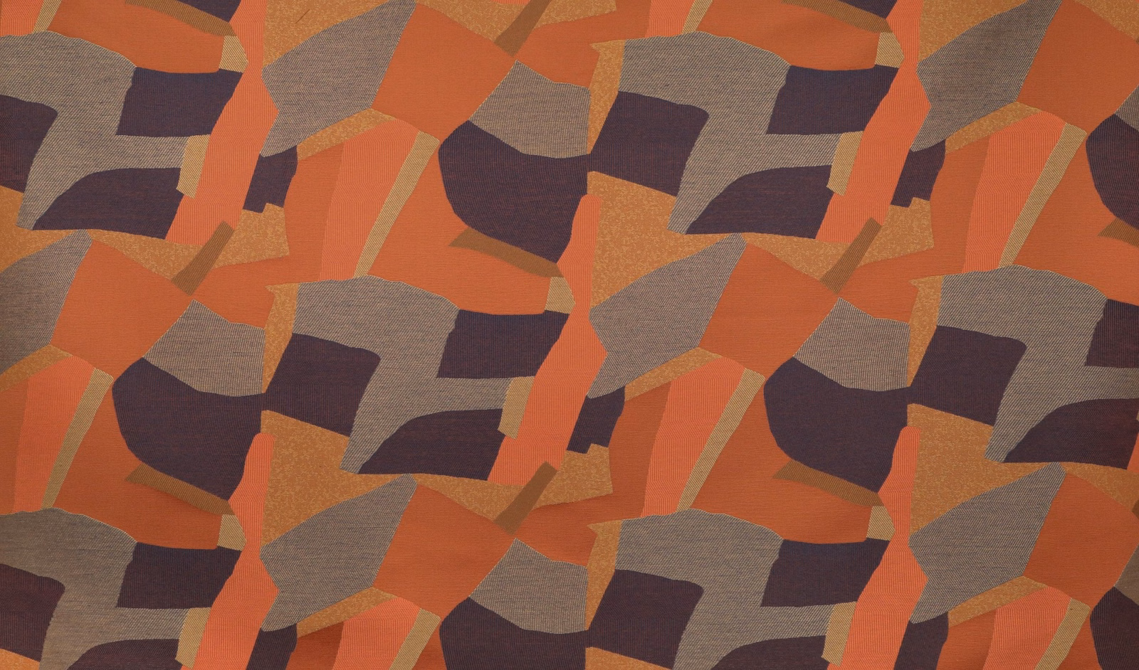 Rust, terracotta, taupe and plum geometric patchwork on a textured woven fabric
