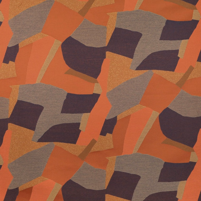 Rust, terracotta, taupe and plum geometric patchwork on a textured woven fabric